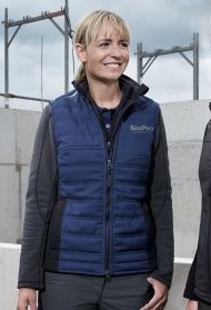 Woman wears blue thermal waistcoat.